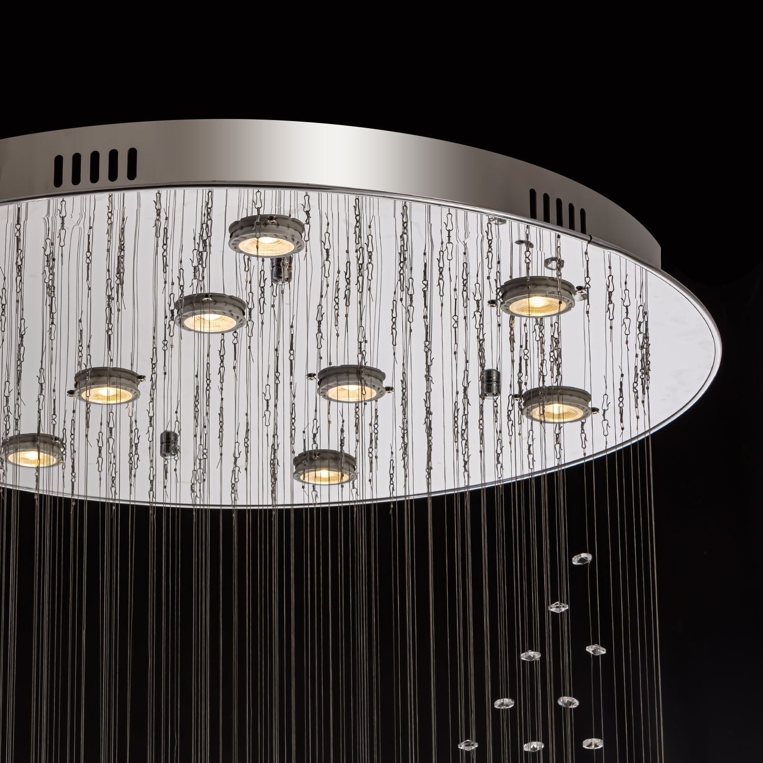 Close-up of modern spiral crystal chandelier showing three sphere raindrop design details | Feyran