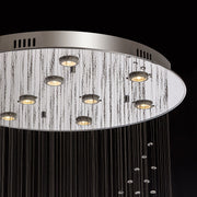 Close-up of modern spiral crystal chandelier showing three sphere raindrop design details | Feyran