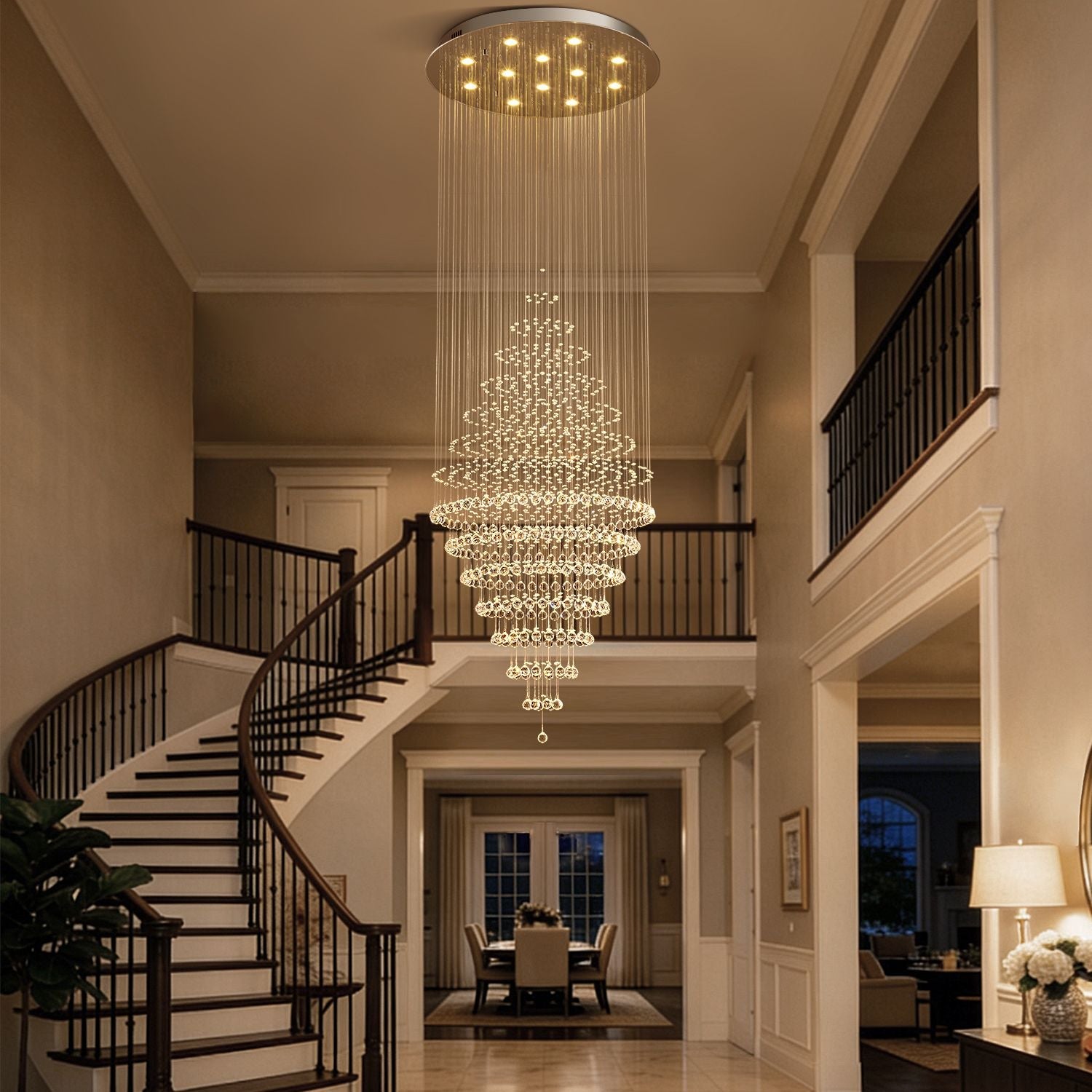 modern round crystal chandelier staircase lighting fixture hanging above curved staircase in luxury home | Feyran