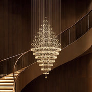 luxury modern round crystal chandelier staircase lighting fixture with spiral crystal strands hanging over curved staircase | Feyran