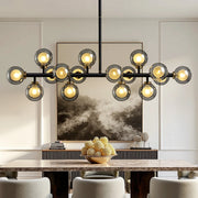 meteor-gray-globe-linear-chandelier-installed-in-dining-room-Feyran-lighting