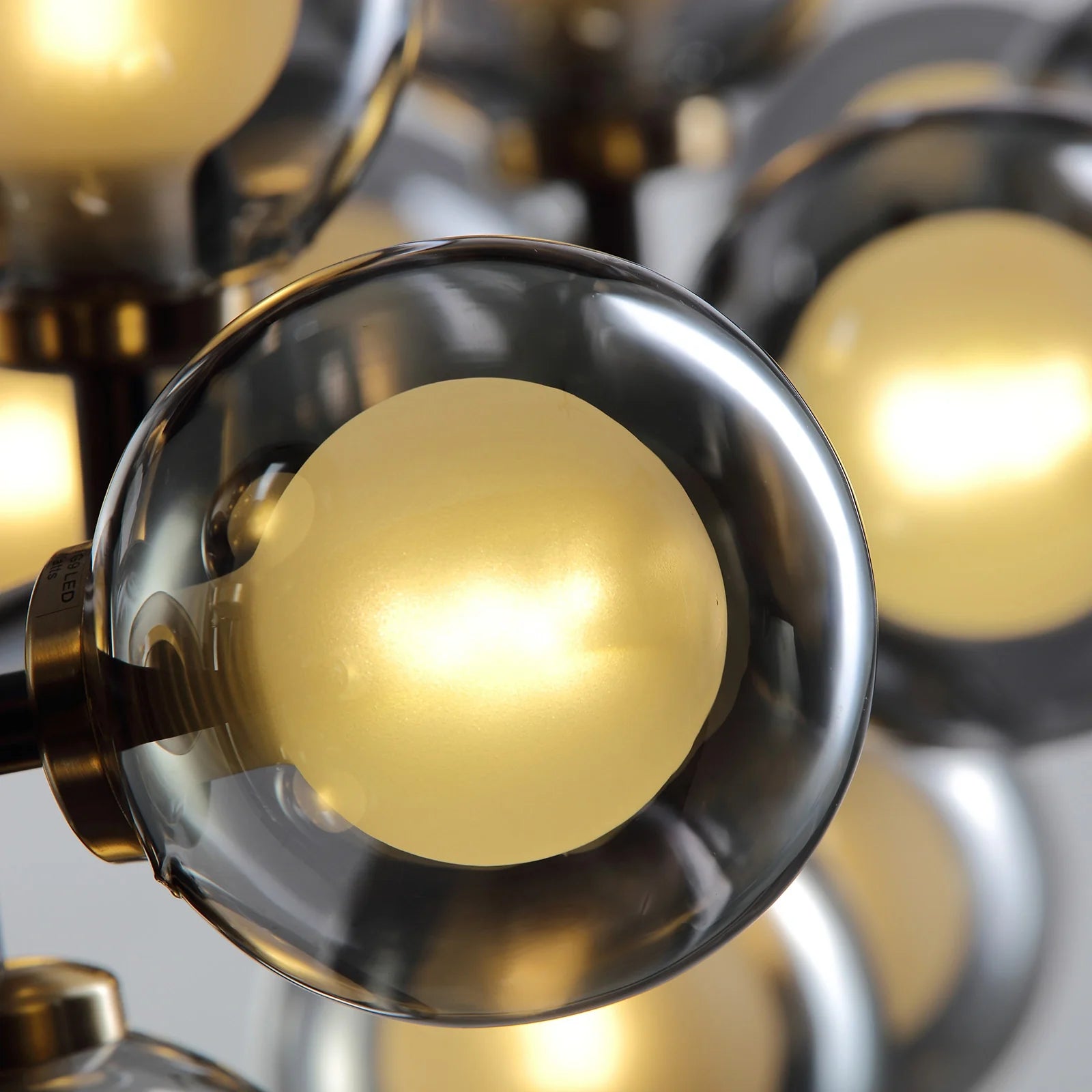 close-up-of-meteor-gray-globe-linear-chandelier-Feyran-lighting