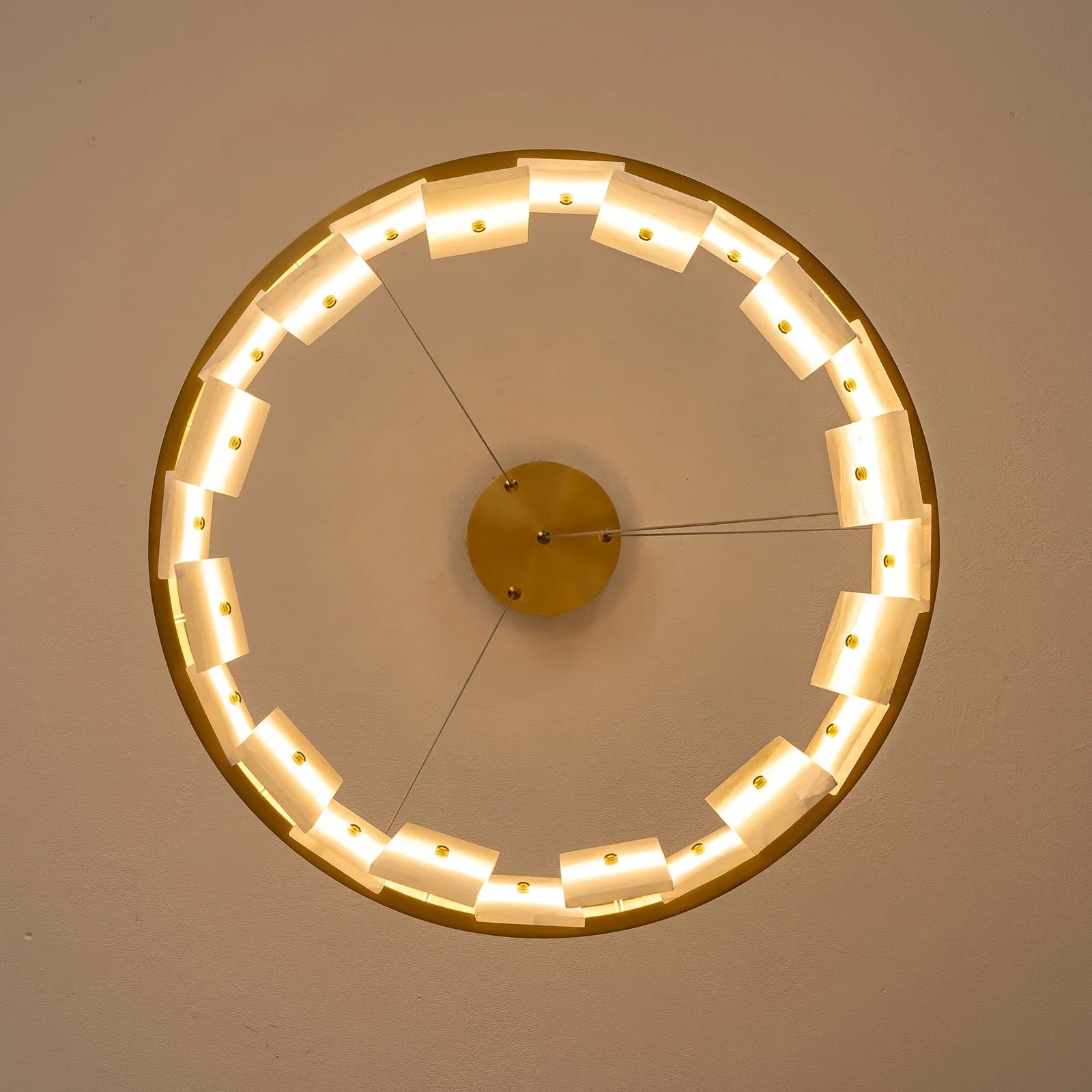 underside-view-modern-round-alabaster-gold-chandelier-with-circular-gold-frame-and-evenly-spaced-alabaster-panels-emitting-warm-light-Feyran-lighting