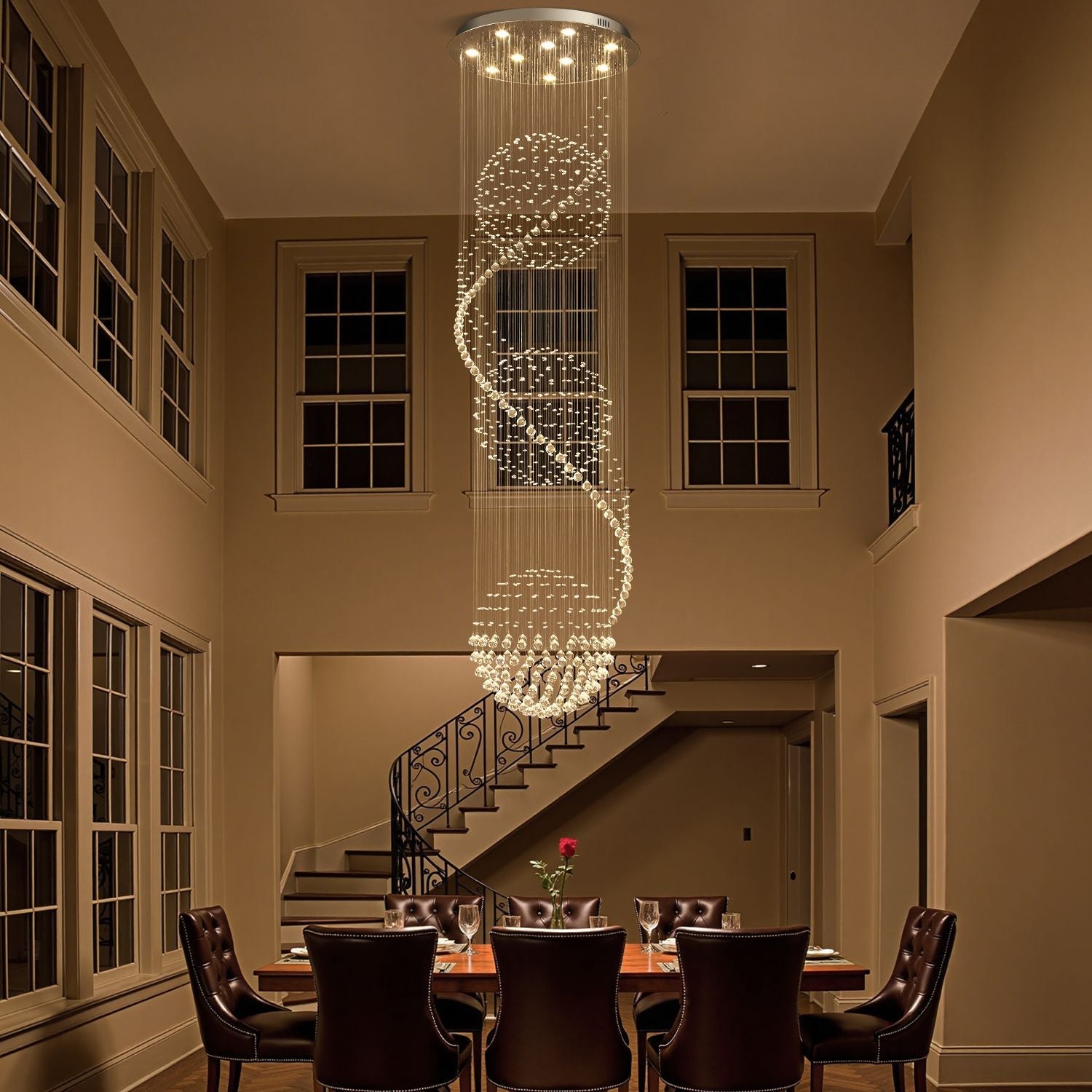 Modern spiral crystal chandelier lighting above a dining table in a luxurious home | Feyran