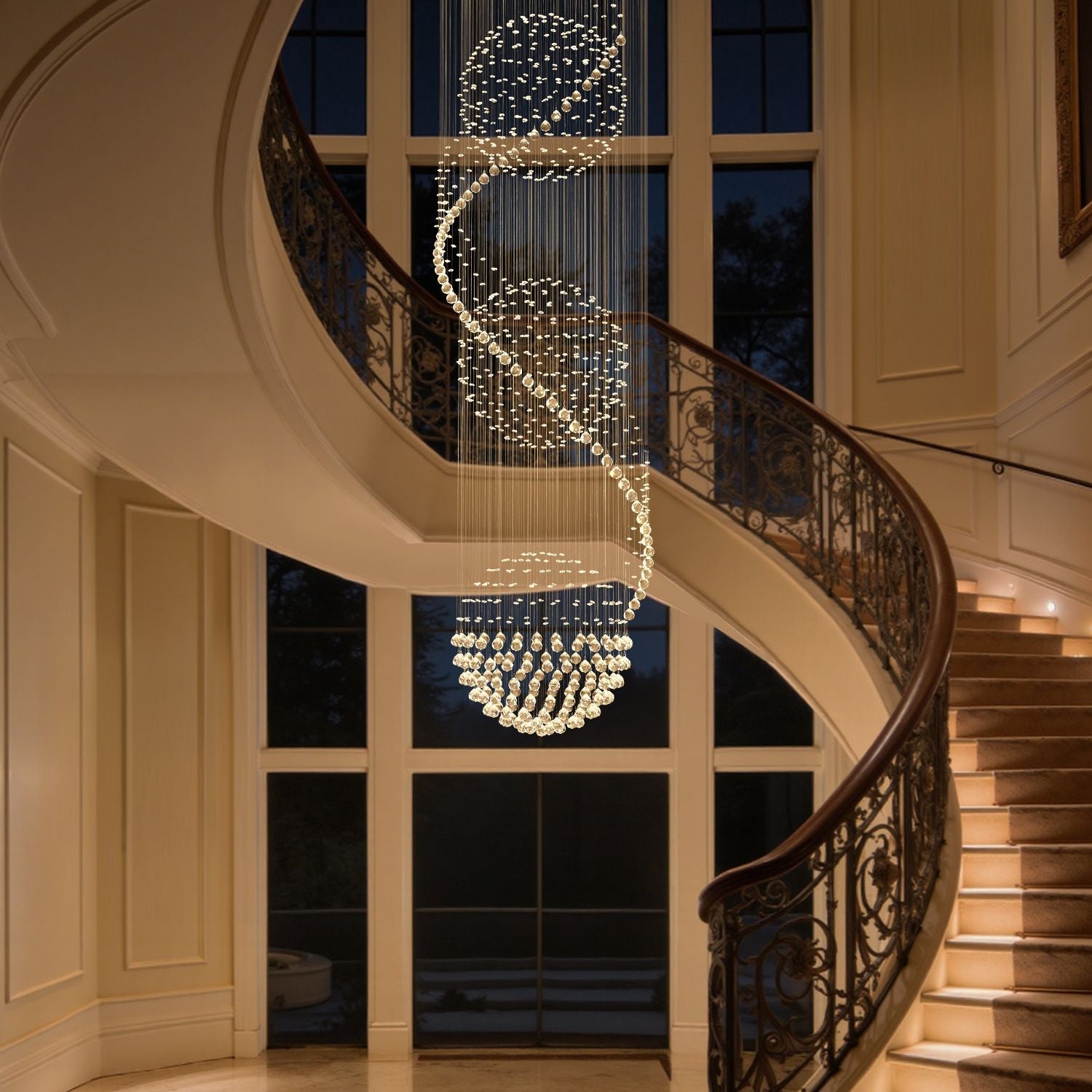 Modern spiral crystal chandelier with three spheres illuminating a stairwell | Feyran