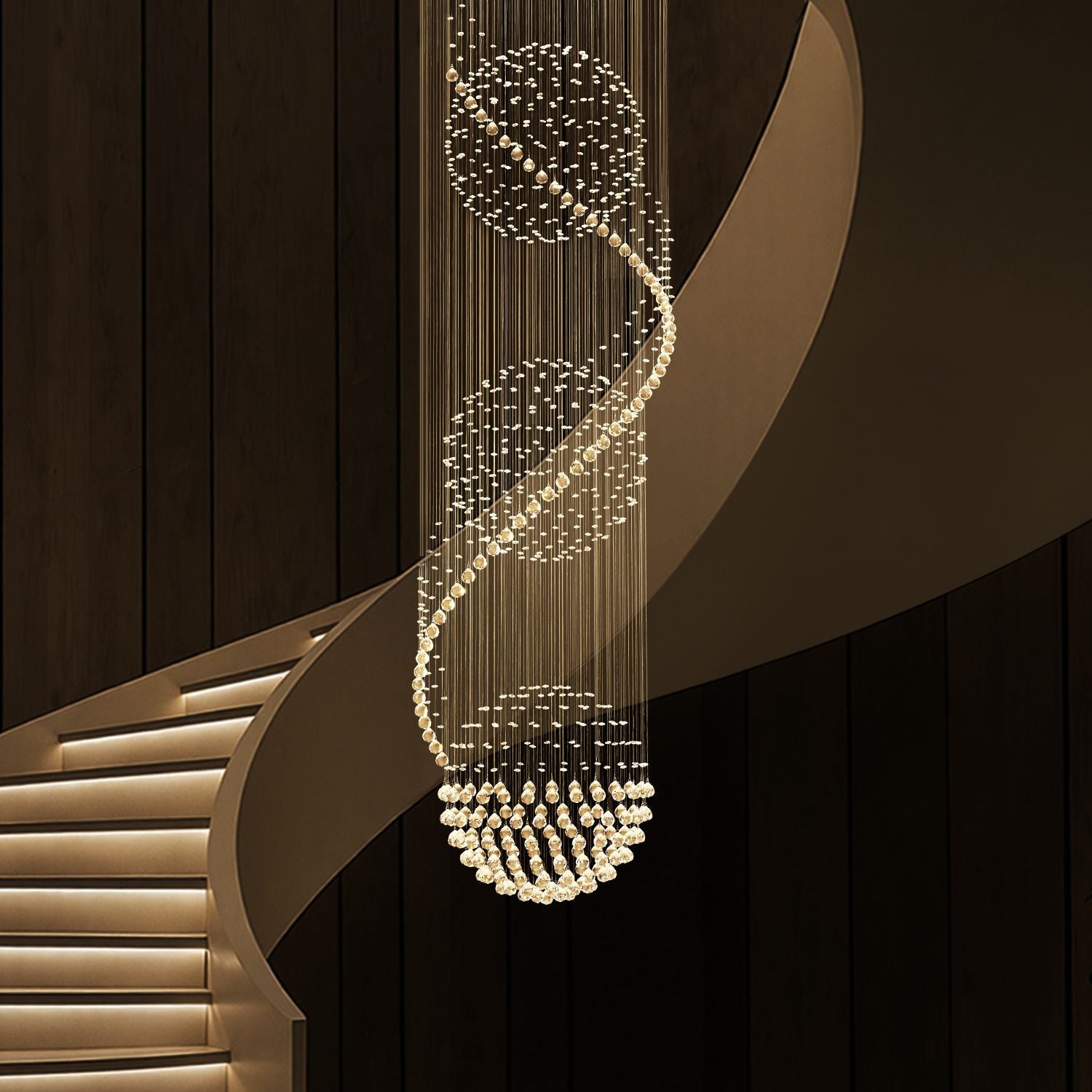 modern spiral three sphere raindrop crystal chandelier lighting hanging over curved staircase in luxury interior | Feyran