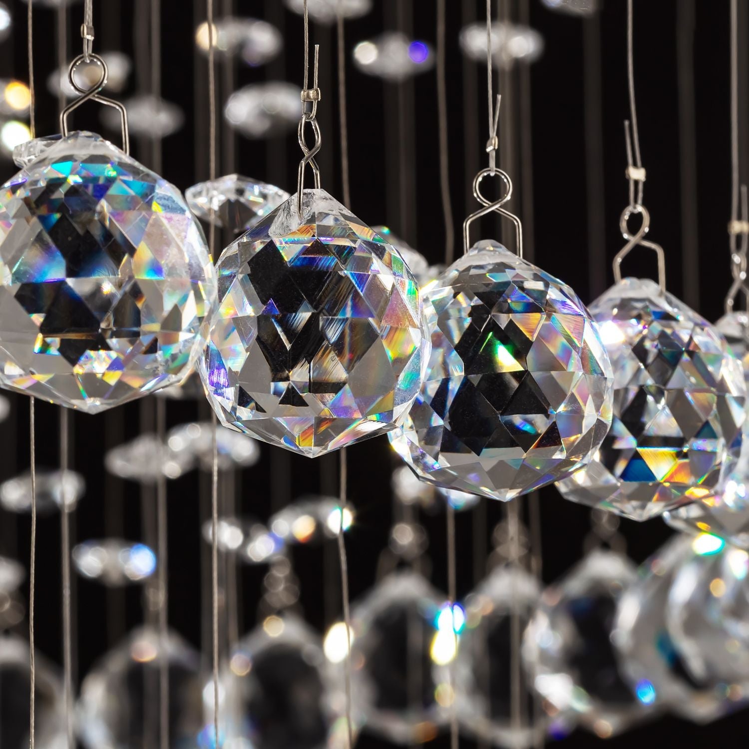 macro detail of premium cut crystal balls reflecting light in luxury modern chandelier | Feyran