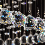 macro detail of premium cut crystal balls reflecting light in luxury modern chandelier | Feyran
